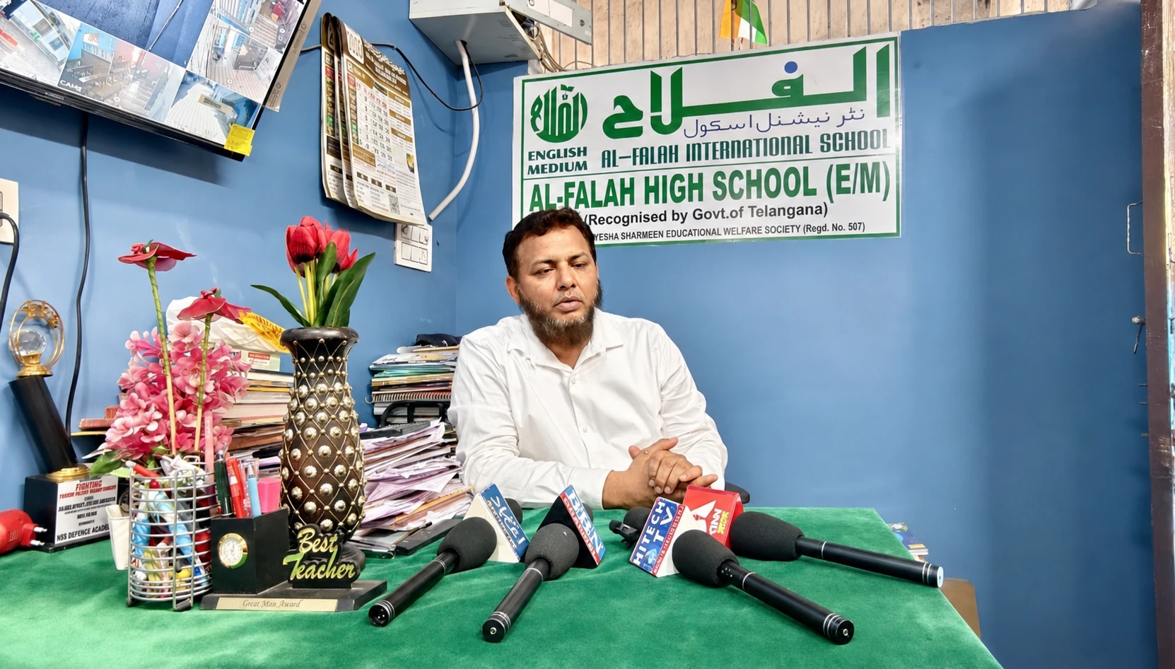 Principal of Al-Falah High School seated in the school office